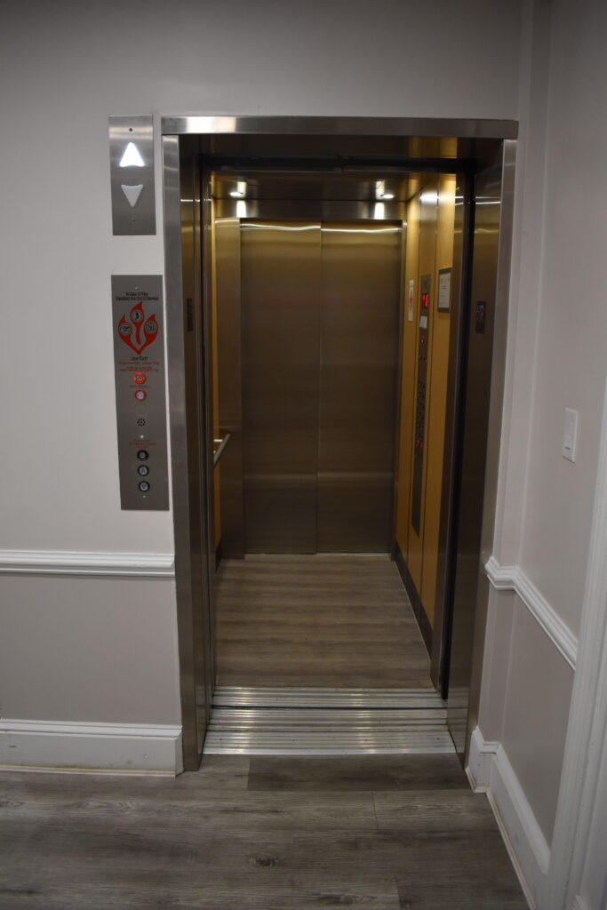 an elevator in a building with a wooden floor