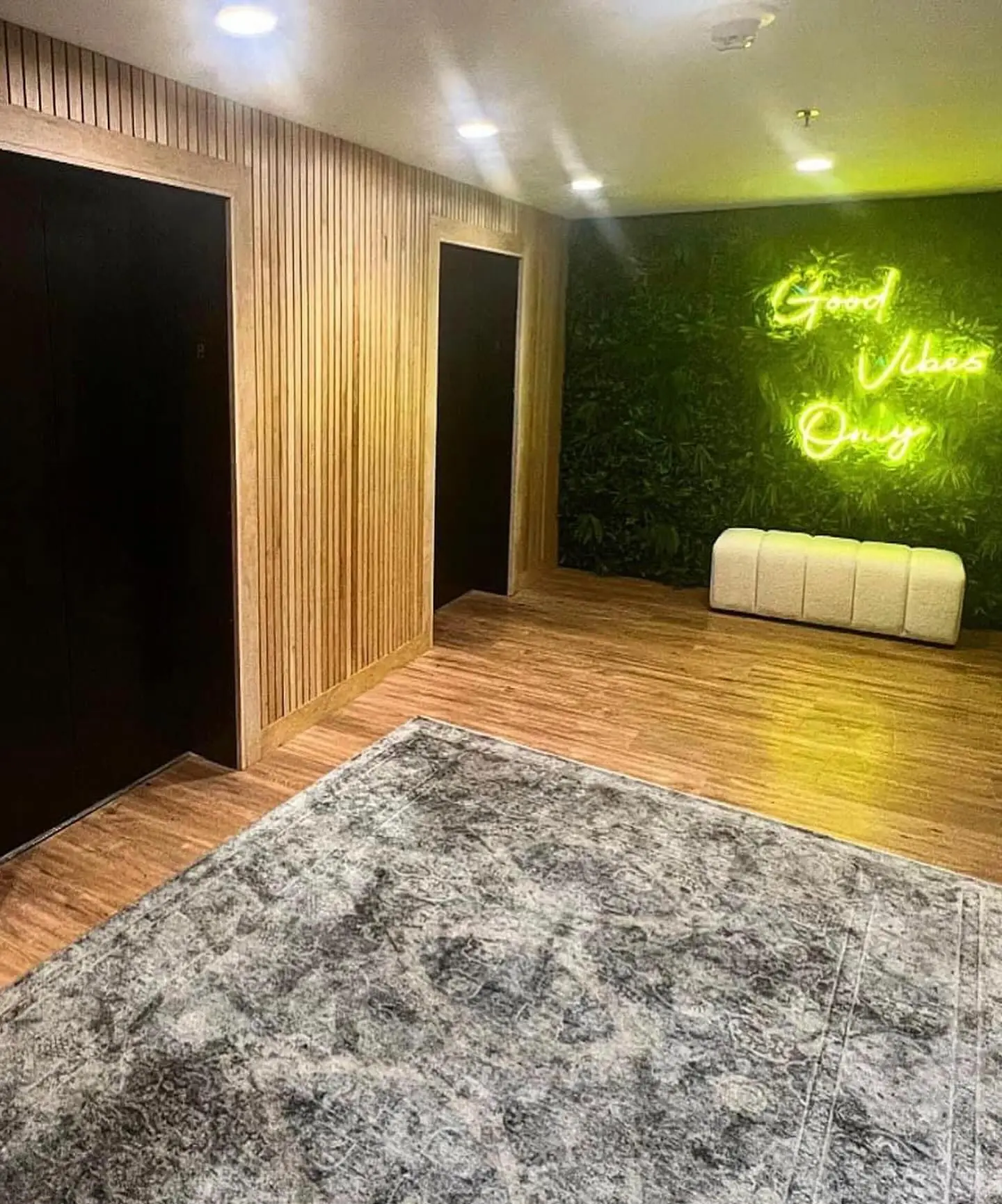 a room with a large carpet and a green wall