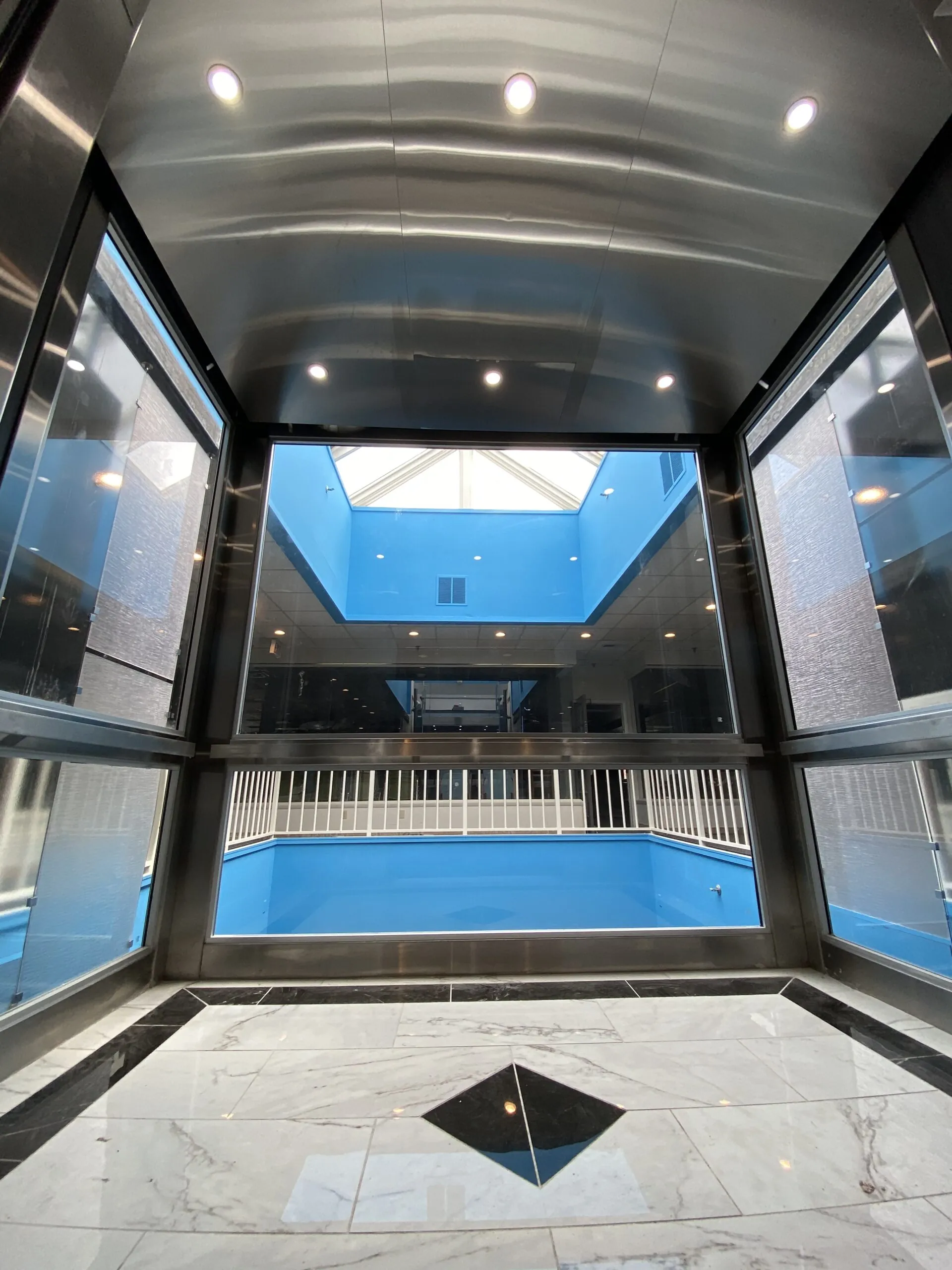 an empty building with a blue pool inside of it