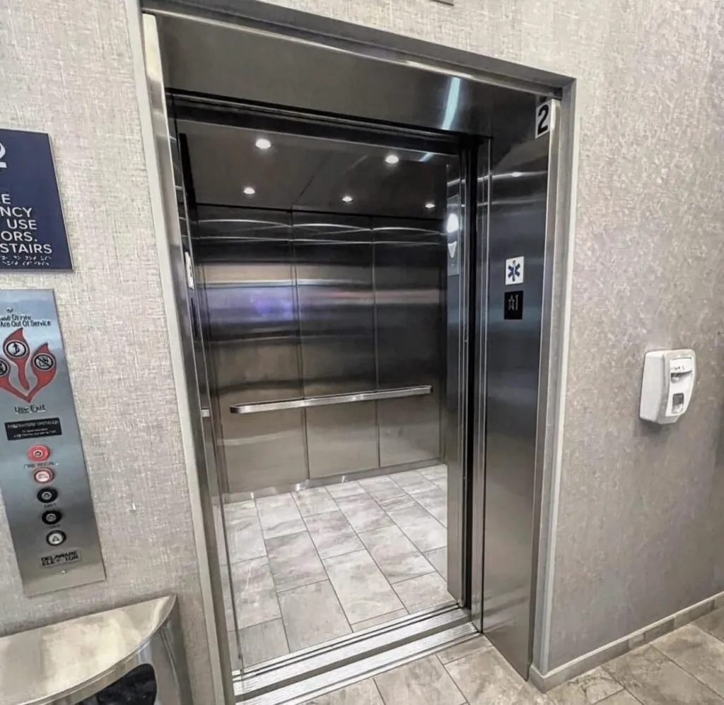 a stainless steel elevator in a bathroom